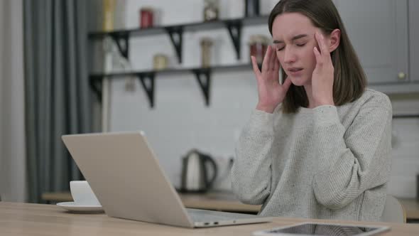 Young Woman Having Headache and Working on Laptop