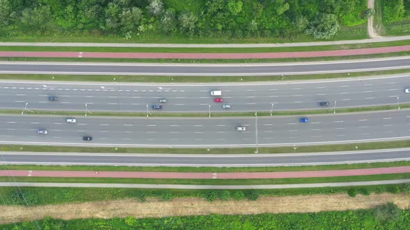 Aerial view over a highway interchange during peak hour traffic.