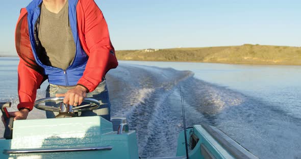 Man riding motorboat in river 4k