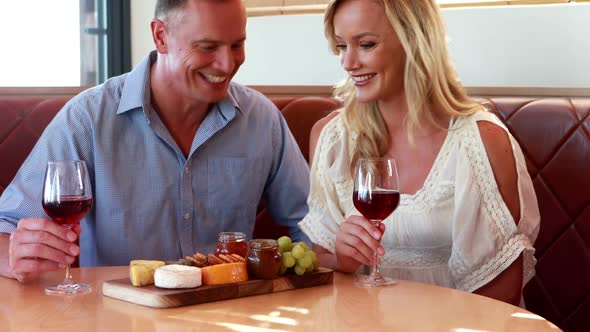 Happy couple interacting while having a wine glass 4k