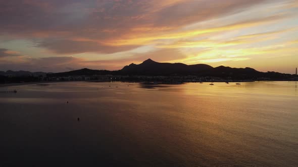 Aerial shot of Beautiful Sunrise in Playa De Alcúdia, Spain. Flying Up