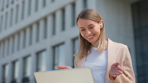 Smiling Businesswoman Having Video Call on Laptop Outdoors