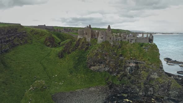 Ireland's Medieval Castle Ruins Aerial View Cliffy Shore of Ocean Gulf Under Cumulus Grey Clouds