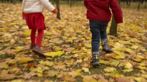 Two Happy Funny Active Smilling Friends Children Kids Boy Girl Walking Running Holding Hands in Park