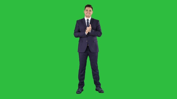 Smiling businessman clapping hands on a Green Screen, Chroma Key.