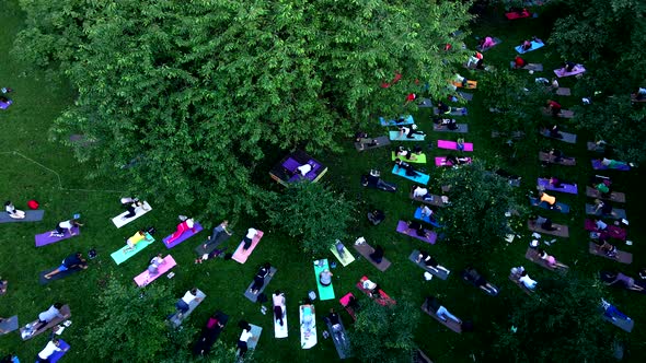 People Do Yoga at City Public Park