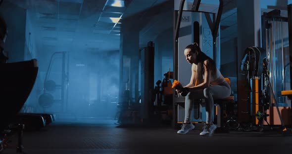 Girl is Sitting on the Bench Tired After Training