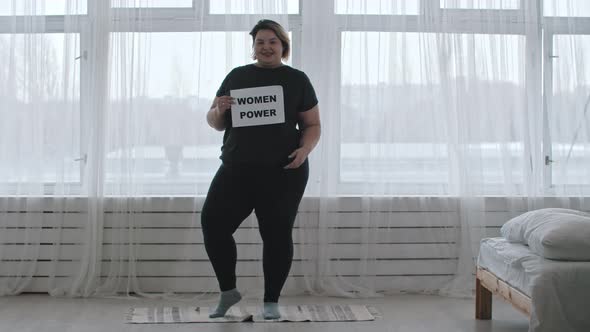 Concept Body Positivity  a Chubby Smiling Woman Holds a Sign with the Inscription WOMEN POWER