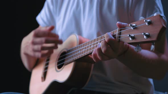 Young Woman Play on Ukulele