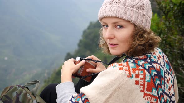 Portrait Of Young Woman Hiker Sitting On A Top Of Mountain