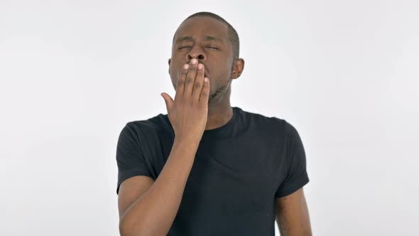 Yawning Young African Man on White Background