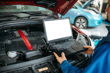  the car engine in auto-service. Vehicle wiring inspection