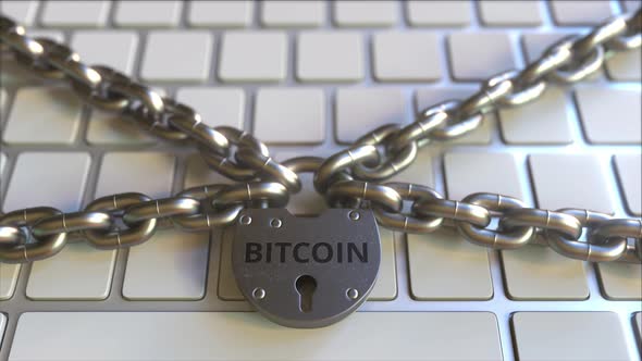 Chains and Padlock with BITCOIN Text on the Keyboard