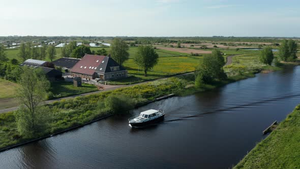 Ship Sailing Across The Canal Near Ossenzijl Town In Overijssel, Friesland, Netherlands. Aerial Pann