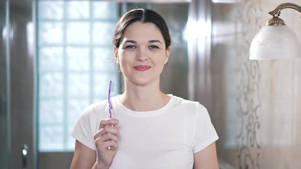 Girl with a Toothbrush in the Bathroom
