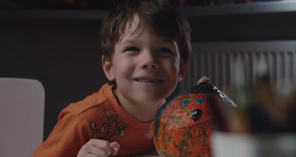 One Boy Decorating and Painting Pumpkin for Halloween