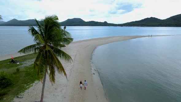 Couple Men and Women Walking on the Beach at the Island Koh Yao Yai Thailand Beach with White Sand