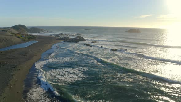 playa de matanzas Chile surf and wind kite surfing, drone shot on the sunset travel right, seagulls