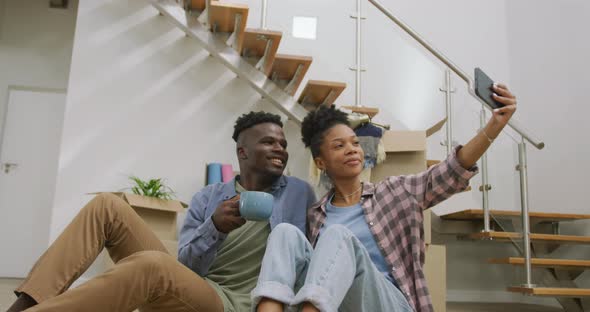 Video of happy african american couple taking selfie after moving into new house