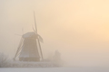 Sunrise over a windmill on a foggy winter morning - PhotoDune Item for Sale