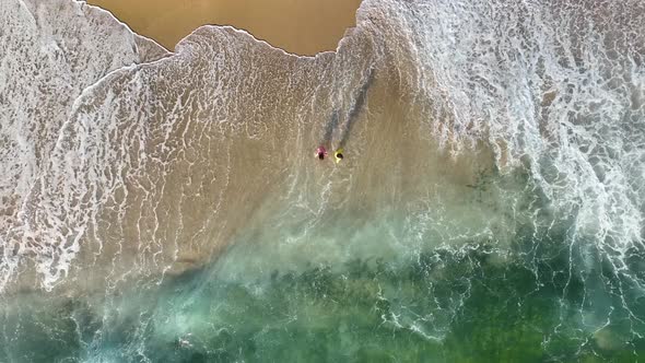 Happy children play on the sea waves