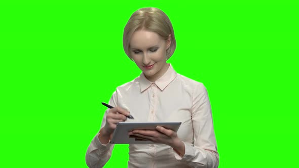 Happy Businesswoman Working with a Pen on a Tablet