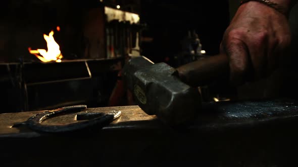 Mid-section of blacksmith holding hammer