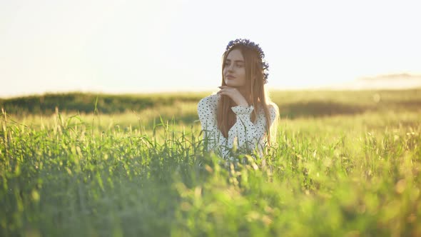 A Young Ukrainian Girl Poses in a Young Wheat Field