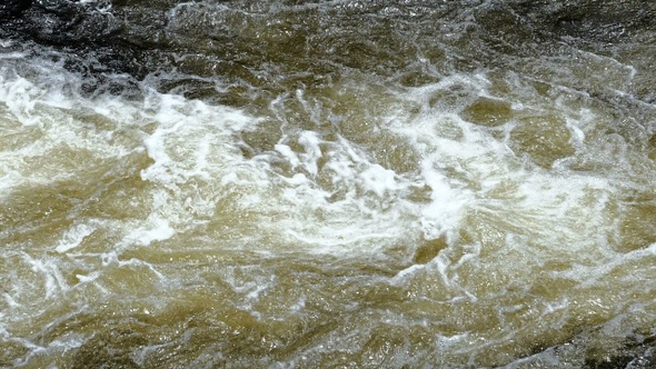 Surface of a shallow fast flowing stream swirling over