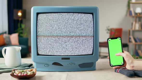 Old Television with Grey Blank Screen on Home Background Living Room Using Smartphone with Chroma