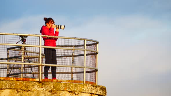 Woman with Camera Taking Photo