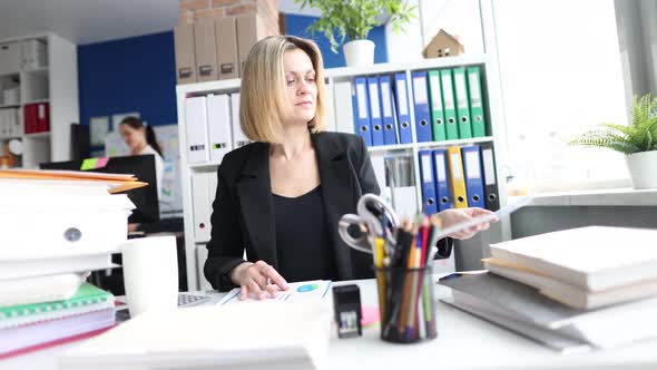 Beautiful Businesswoman Working with Laptop and Documents in Office