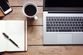 Open laptop with notepad and smartphone on desk from above - PhotoDune Item for Sale