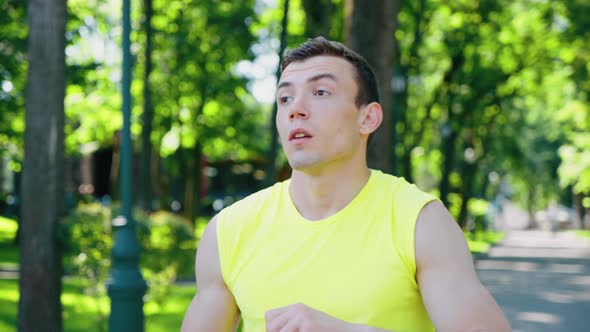 Man Drinking Water After Workout in Park