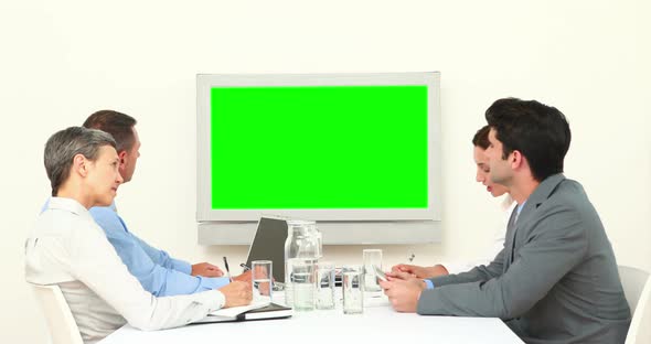 Business Team Looking at White Screen and Talking