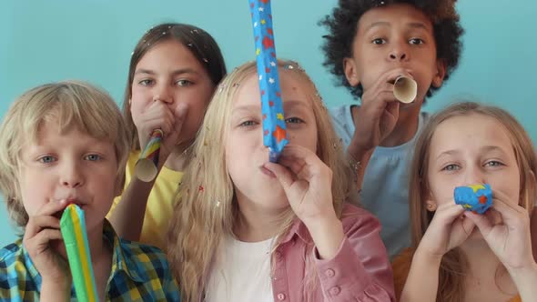 Kids Blowing Party Horns on Camera