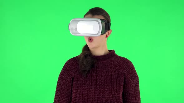 Happy Young Woman with Virtual Reality Headset or 3d Glasses. Green Screen