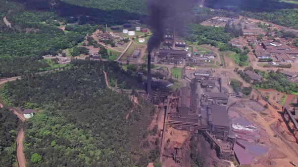 Aerial view of dark toxic smoke rising up from stack of mine plant in Dominican Republic - Sad envir