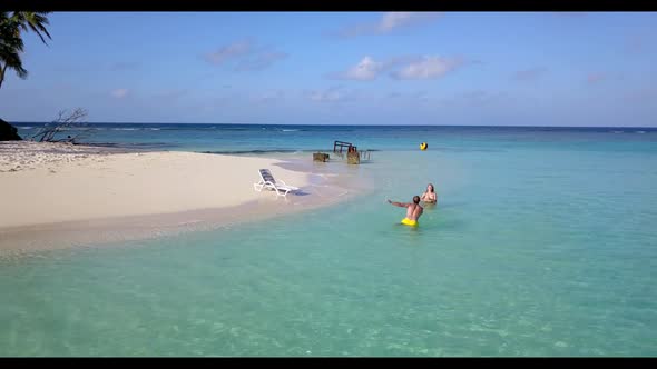 Man and lady suntan on beautiful seashore beach journey by blue green ocean and white sandy backgrou