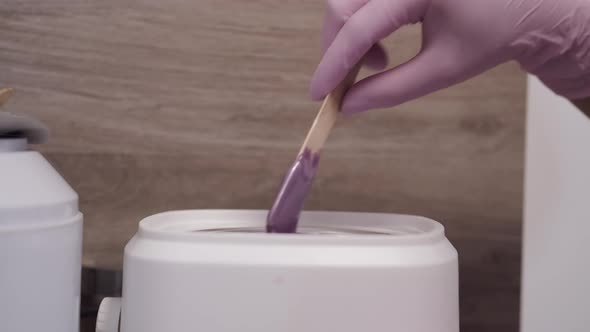 Closeup of Process of Taking Paste for Hair Removal Procedure