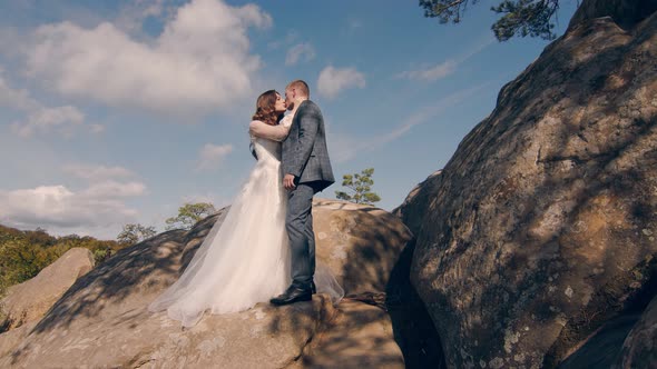 Newlywed Wedding Couple Walking in the Park. Two Young People in Love Meet Each Other's Eyes