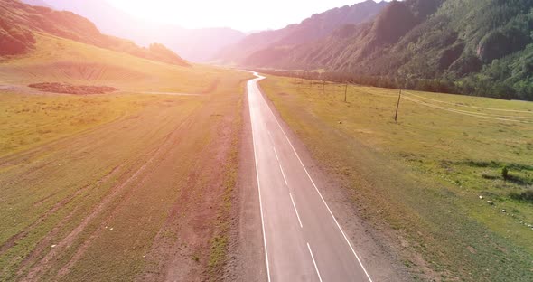 Flight Over Mountain Asphalt Highway Road and Meadow