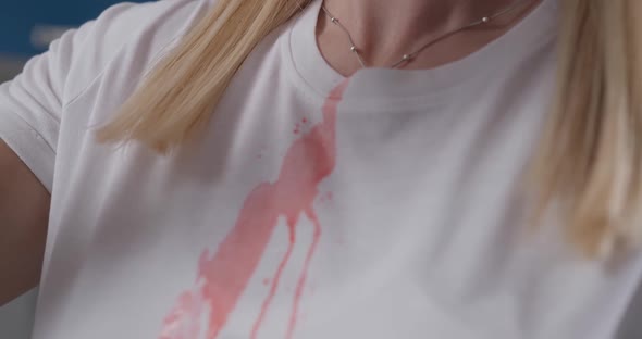 Red Liquid Pours on Woman's White Tshirt