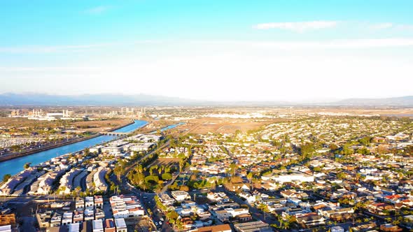 Panning drone shot of the San Gabriel River over to the Seal Beach Pier.