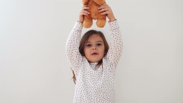 Funny Preschool Girl Making with Teddy Bear Toy Candid Lifestyle Child Portrait with Emotions