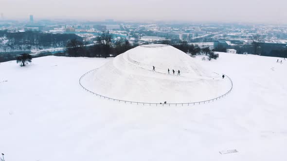 Group of Hikers on Kopiec Krakusa (Krak Mound) Covered with Snow in Krakow Poland