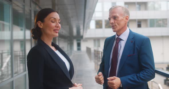 Business Colleagues Smiling and Talking Outside Office Building