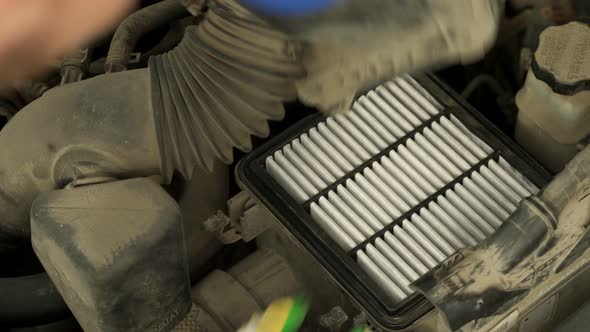 Man Hands in Work Gloves Change Car Air Filter Closeup