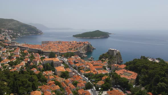 Aerial drone forwarding shot of an old town Dubrovnik, Croatia with the view of port on the seaside