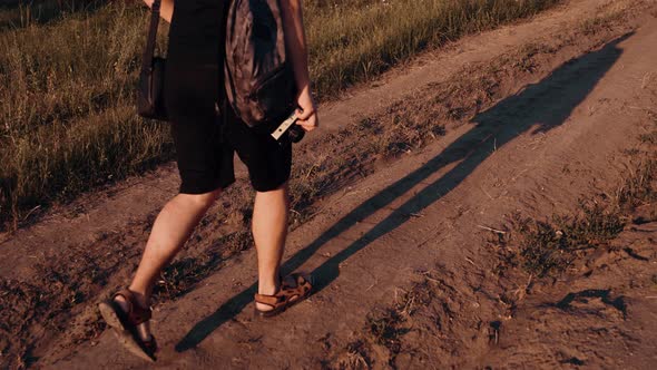 Legs Shadow Young Man Dressed Black Shorts Who Has Rug His Back His Hand Holds Retro Camera